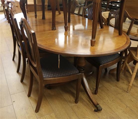 A mahogany twin pillar dining table and eight chairs, (6 plus 2 carvers). W.213cm with leaf